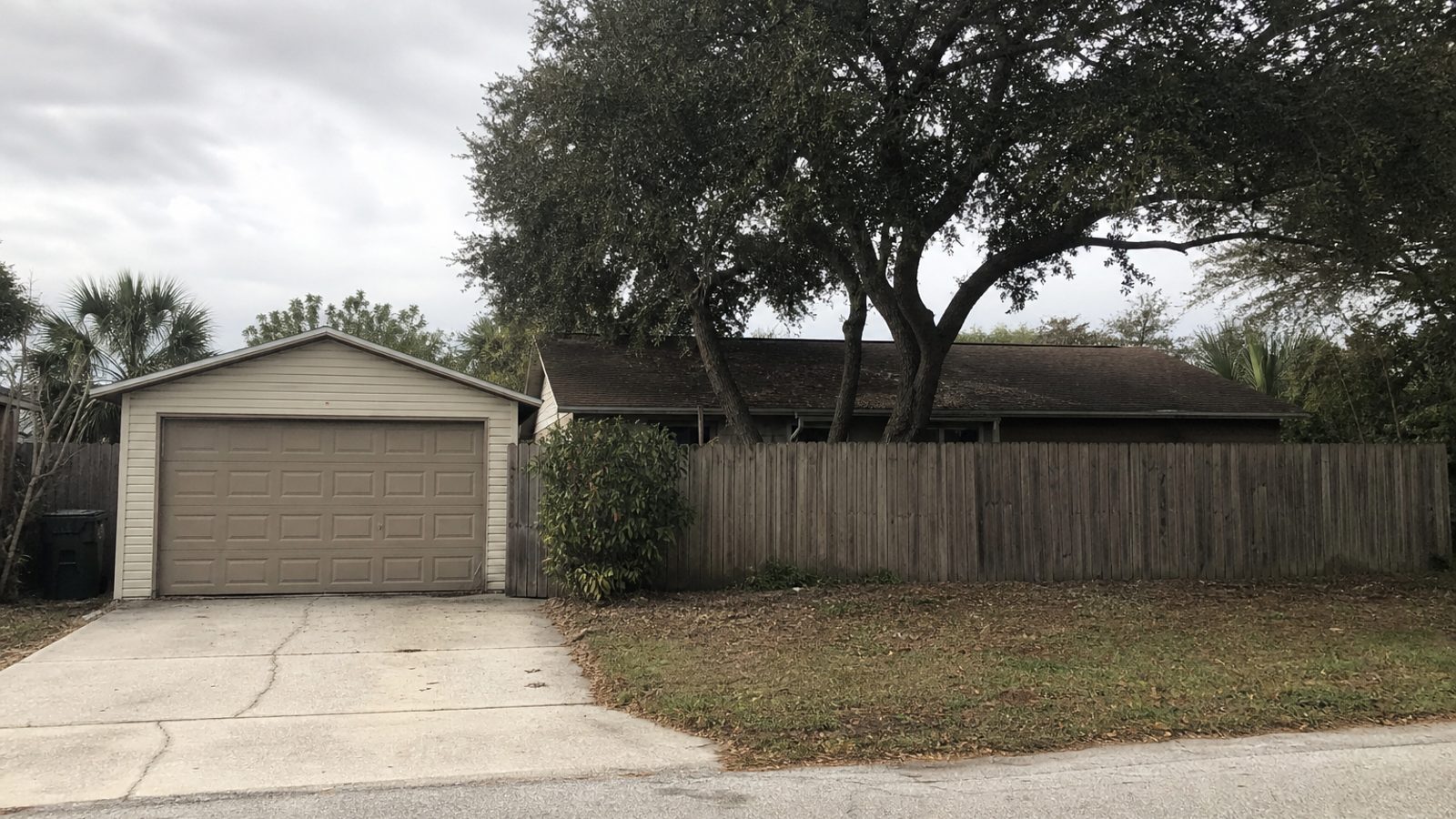 Brevard County coastal residential street with older construction and sandy soil